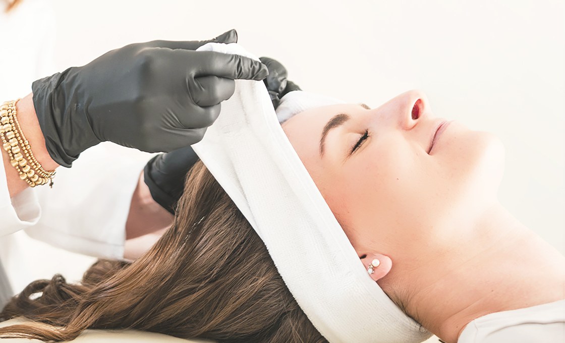 A Golden Pearl provider performing a facial treatment in the St. Augustine studio